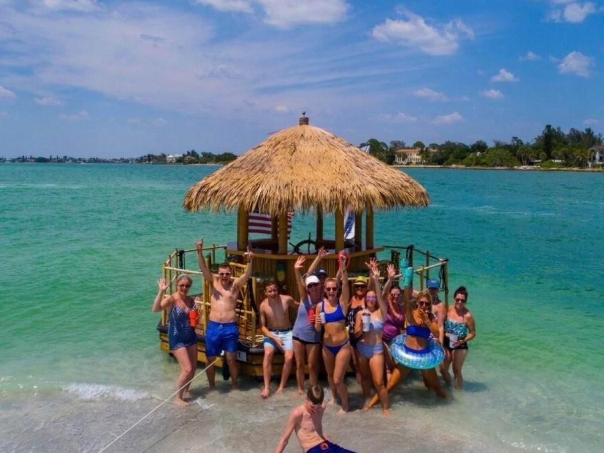 a group of people on a beach near a body of water