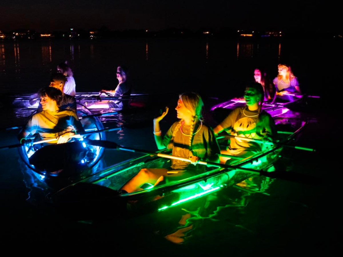 a group of people sitting at a table in a dark room