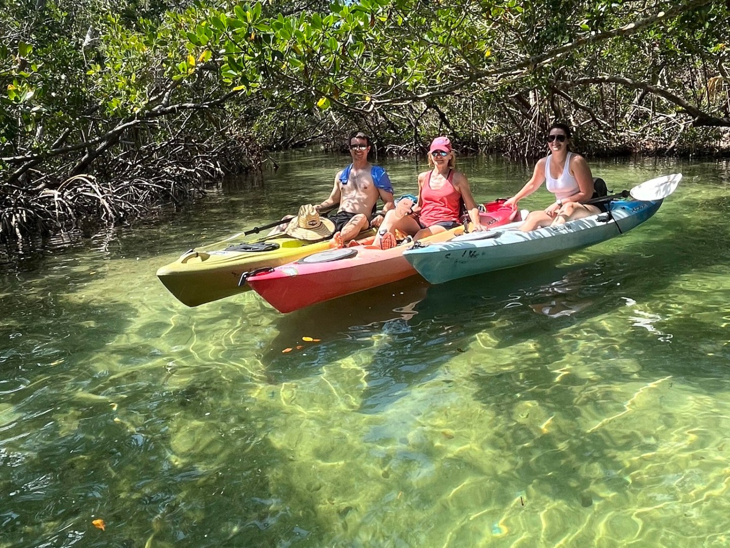 a group of people riding on the back of a boat in the water